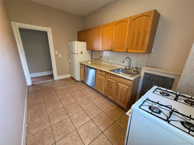 a kitchen with a stove top oven sink and cabinets
