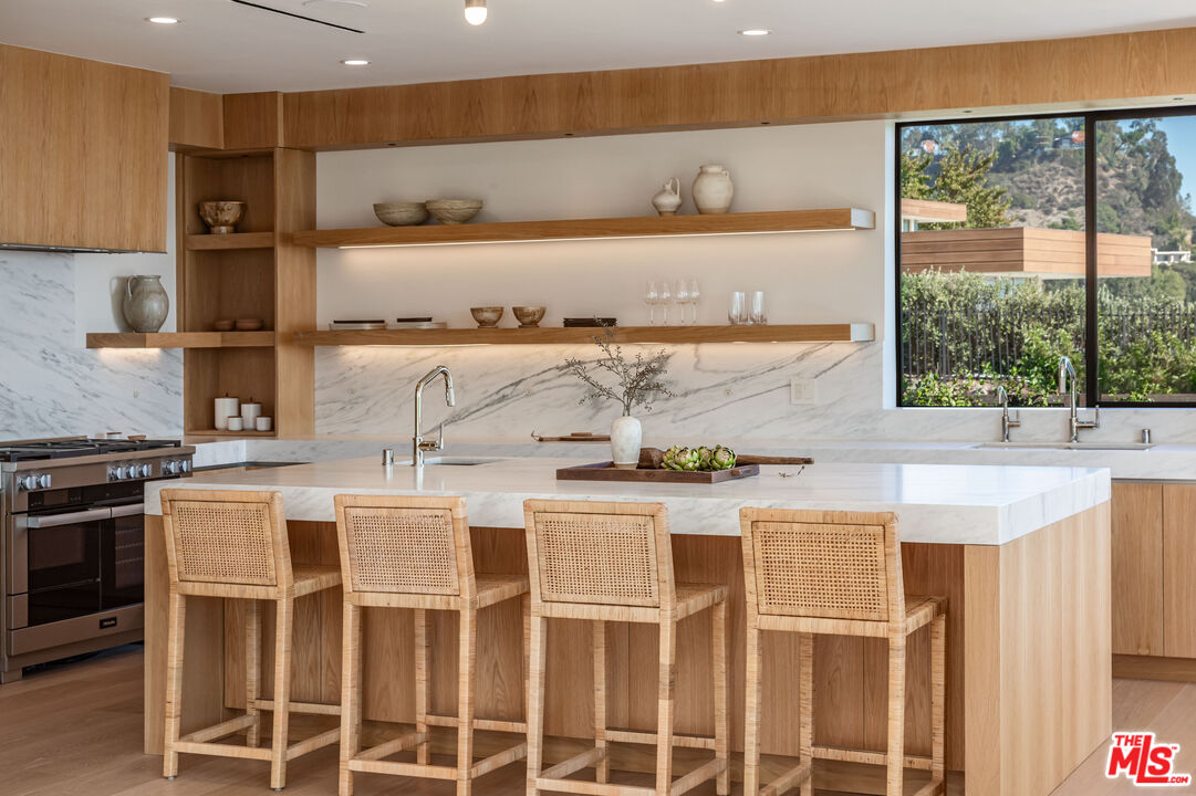 1705 Carla Ridge Beverly Hills, CA 90210 - Photo 11 of 53 a kitchen with a stove a sink and a refrigerator