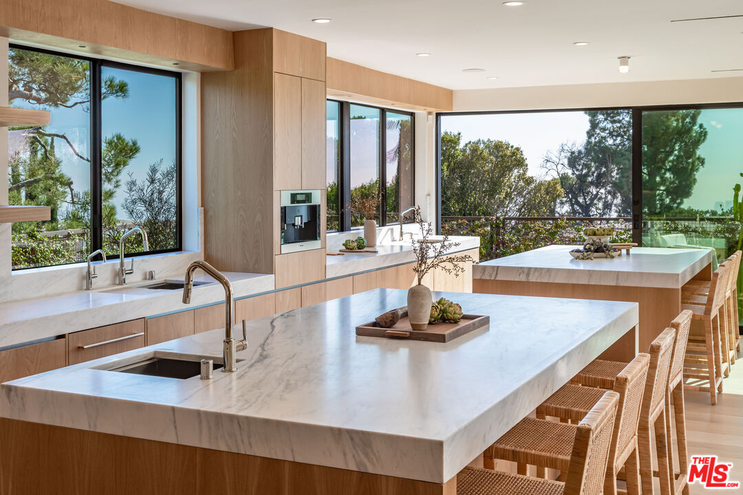 1705 Carla Ridge Beverly Hills, CA 90210 - Photo 12 of 53 a kitchen with a large window and a sink