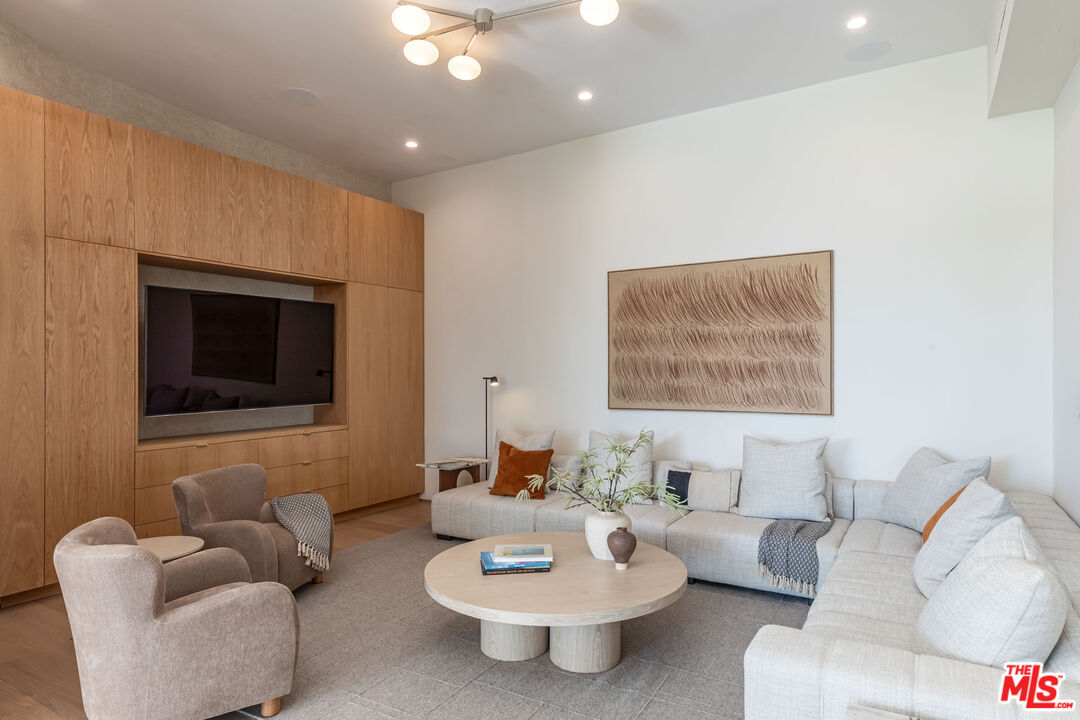 1705 Carla Ridge Beverly Hills, CA 90210 - Photo 14 of 53 a living room with furniture and a fireplace