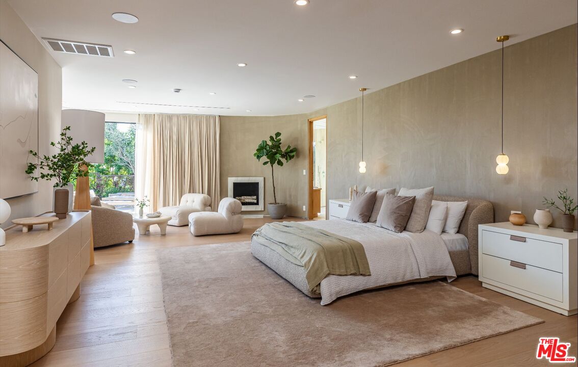 1705 Carla Ridge Beverly Hills, CA 90210 - Photo 16 of 53 a spacious bedroom with a large bed and a couch