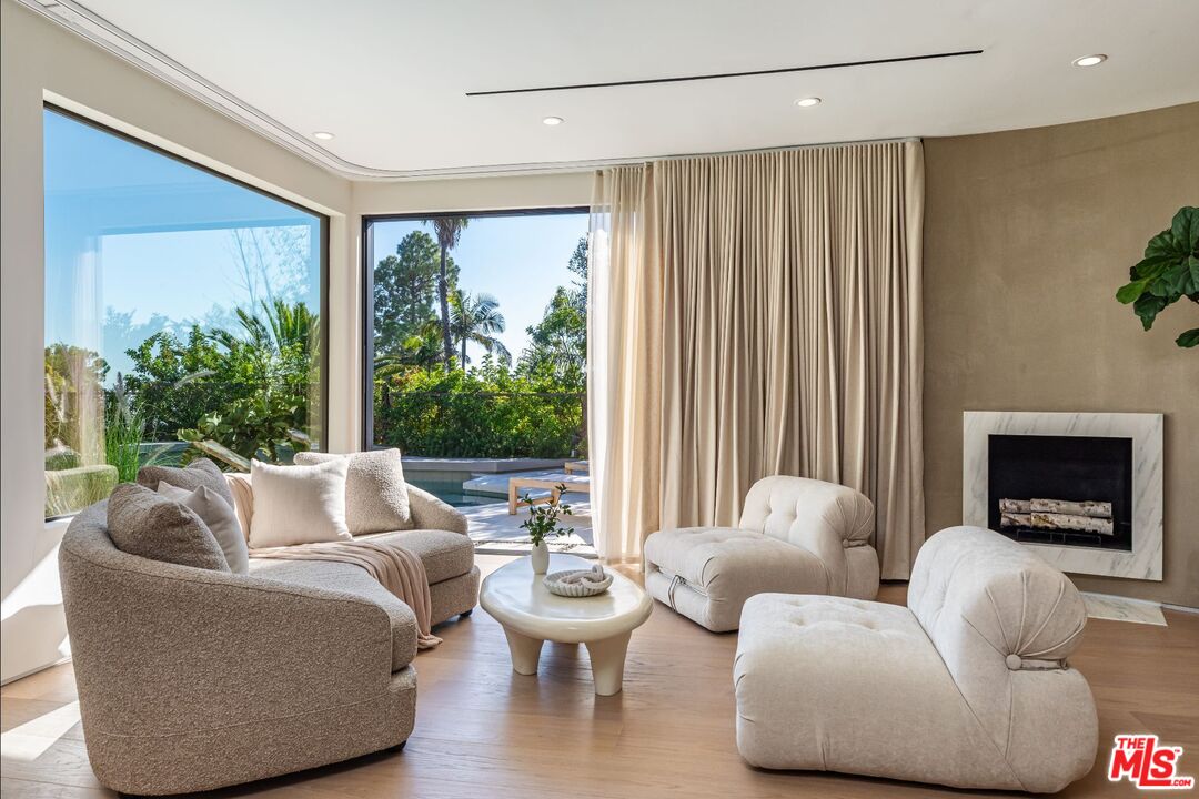 1705 Carla Ridge Beverly Hills, CA 90210 - Photo 18 of 53 a living room with furniture and a fireplace