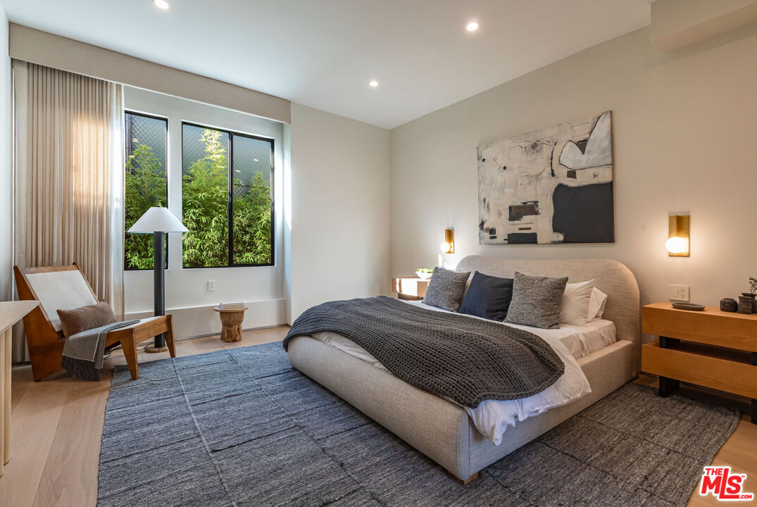 1705 Carla Ridge Beverly Hills, CA 90210 - Photo 25 of 53 a bedroom with a bed and wooden floor