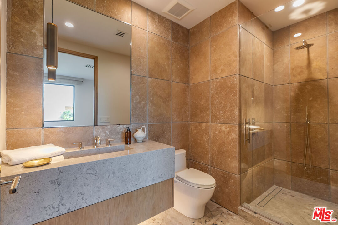 1705 Carla Ridge Beverly Hills, CA 90210 - Photo 30 of 53 a bathroom with a sink toilet and shower