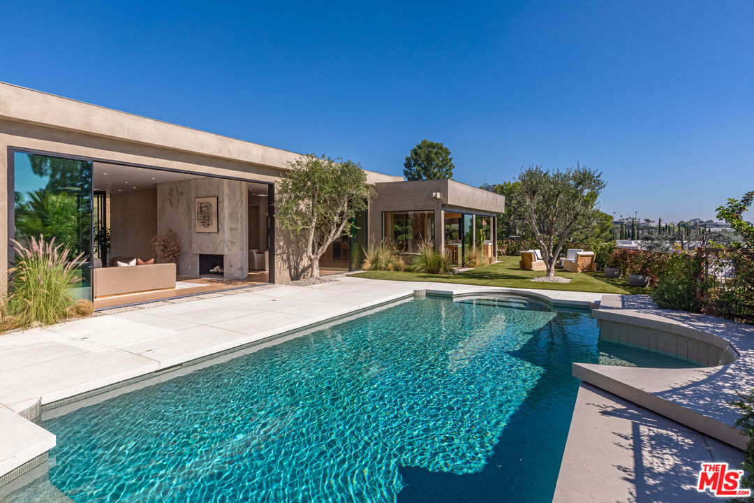 1705 Carla Ridge Beverly Hills, CA 90210 - Photo 32 of 53 a view of a house with pool and chairs