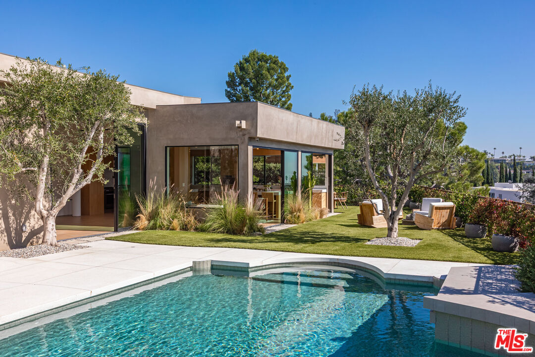 1705 Carla Ridge Beverly Hills, CA 90210 - Photo 33 of 53 a view of house with backyard outdoor seating and swimming pool