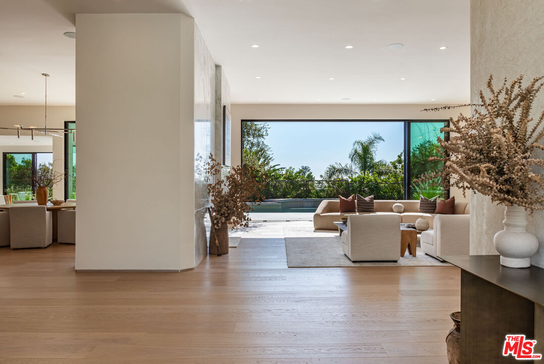 1705 Carla Ridge Beverly Hills, CA 90210 - Photo 4 of 53 a living room with fireplace furniture and a large window