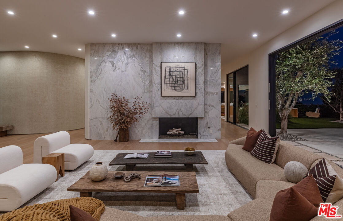 1705 Carla Ridge Beverly Hills, CA 90210 - Photo 45 of 53 a living room with furniture and a fireplace