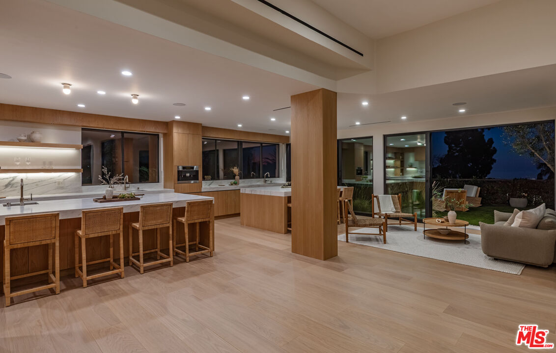 1705 Carla Ridge Beverly Hills, CA 90210 - Photo 46 of 53 a group of chairs in kitchen and a large window
