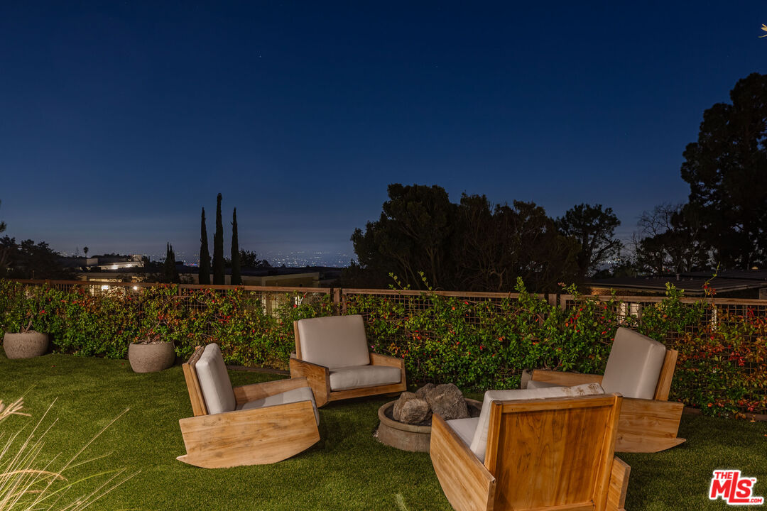 1705 Carla Ridge Beverly Hills, CA 90210 - Photo 53 of 53 a view of a terrace with couches and wooden fence