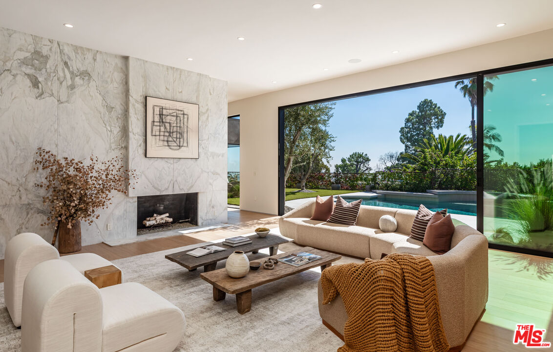 1705 Carla Ridge Beverly Hills, CA 90210 - Photo 6 of 53 a living room with furniture and a fireplace