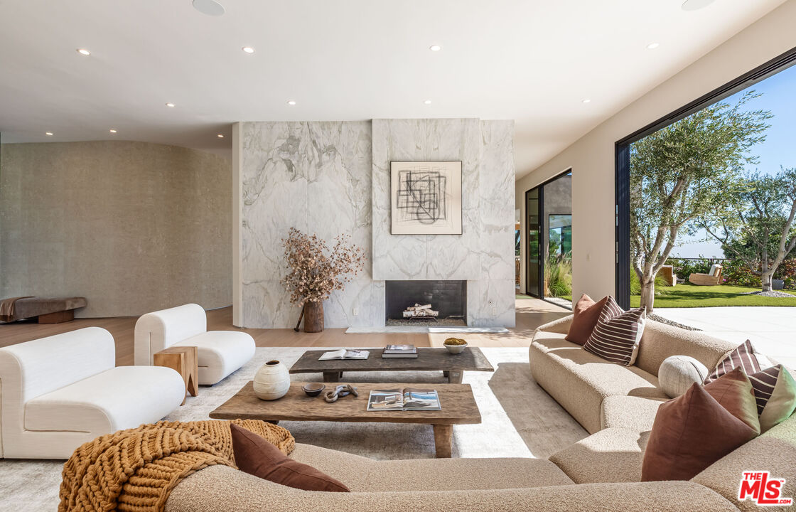 1705 Carla Ridge Beverly Hills, CA 90210 - Photo 7 of 53 a living room with furniture and a large window