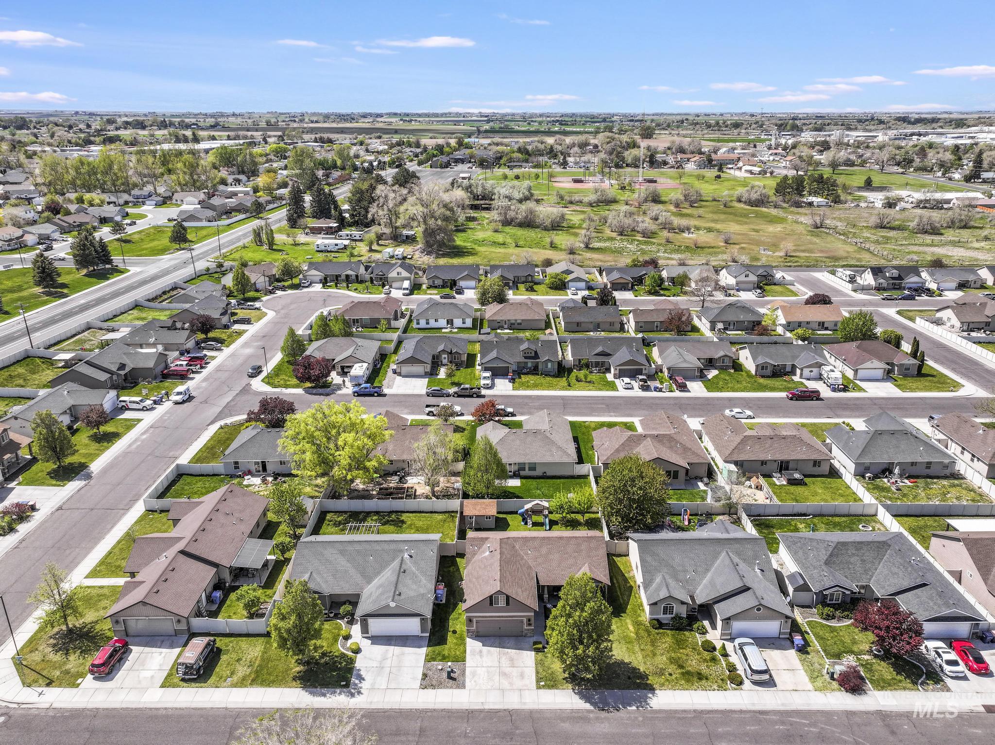 446 Noble Street Twin Falls, ID 83301 - Photo 37 of 42 Aerial perspective showcasing a residential neighborhood with single-story homes, paved streets, and green landscaping