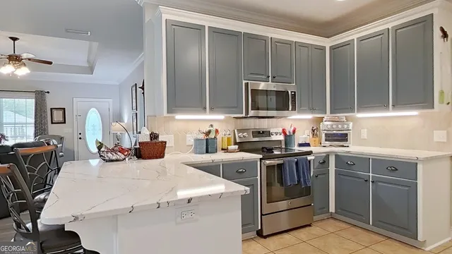 a kitchen with a stove a sink and a microwave