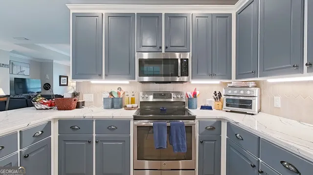 a kitchen with a sink stove and microwave