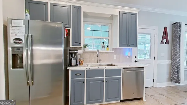 a kitchen with stainless steel appliances a refrigerator sink and cabinets