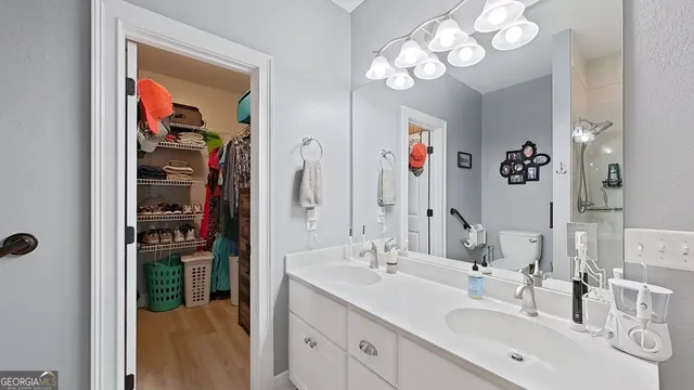 a bathroom with a sink a mirror and a shower