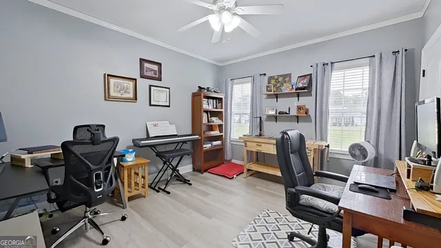 a view of a workspace with furniture and a window