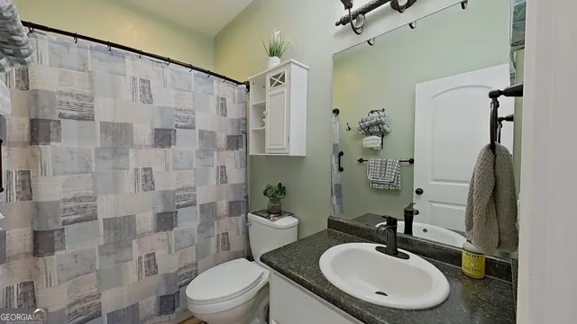 a bathroom with a granite countertop sink a mirror and vanity
