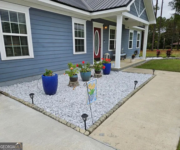 a view of field with trees in the background