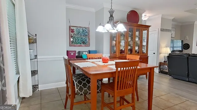 a view of a dining room with furniture and chandelier