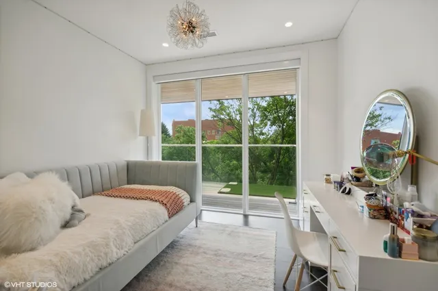 a spacious bedroom with a bed and a large window