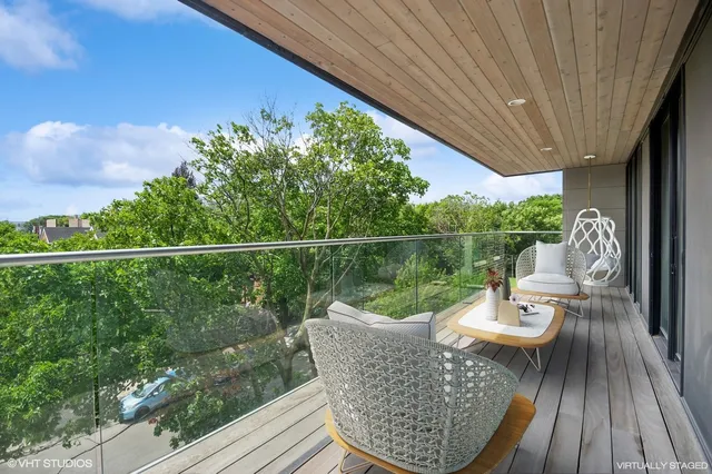 a view of a chair and tables in the balcony