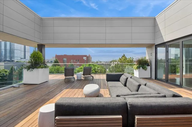 a living room with furniture and a floor to ceiling window