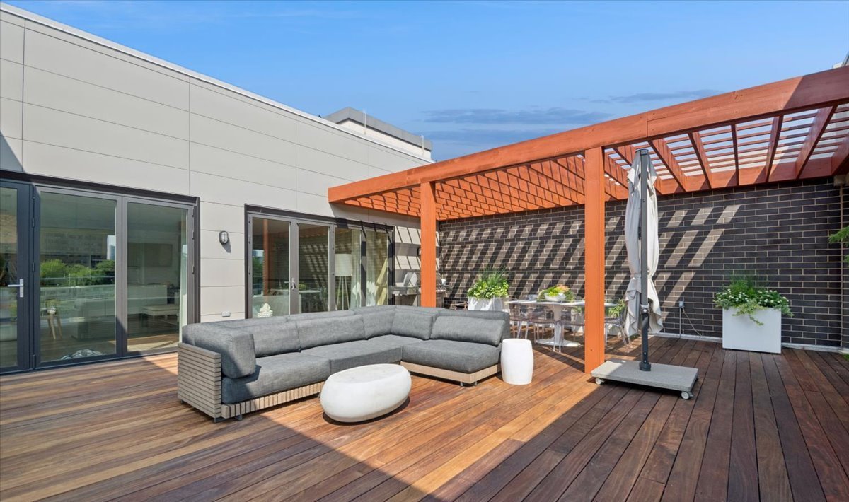 1625 North Burling Street, Unit 401 Chicago, IL 60614 - Photo 38 of 42 a balcony with furniture and wooden floor