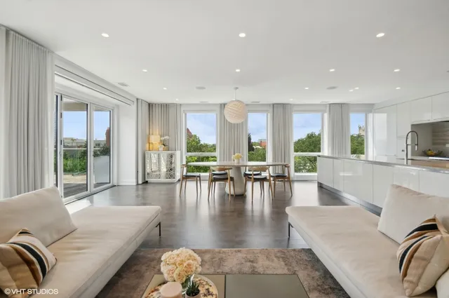 a living room with furniture wooden floor and a large window