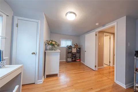 a view of a storage & utility room with closet and wooden floor