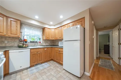 a kitchen with stainless steel appliances granite countertop a refrigerator and a sink