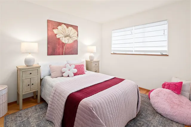 a bedroom with bed and a large window