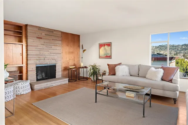 a living room with furniture and a fireplace