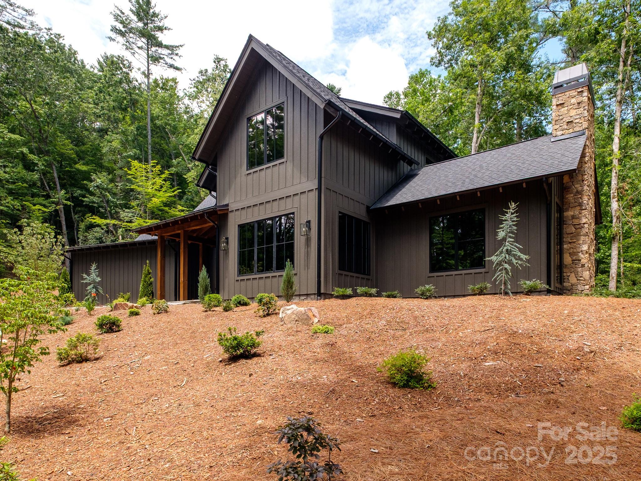 115 Rockbrook Overlook Brevard, NC 28712 - Photo 4 of 33 a front view of a house with a yard outdoor space and glass windows