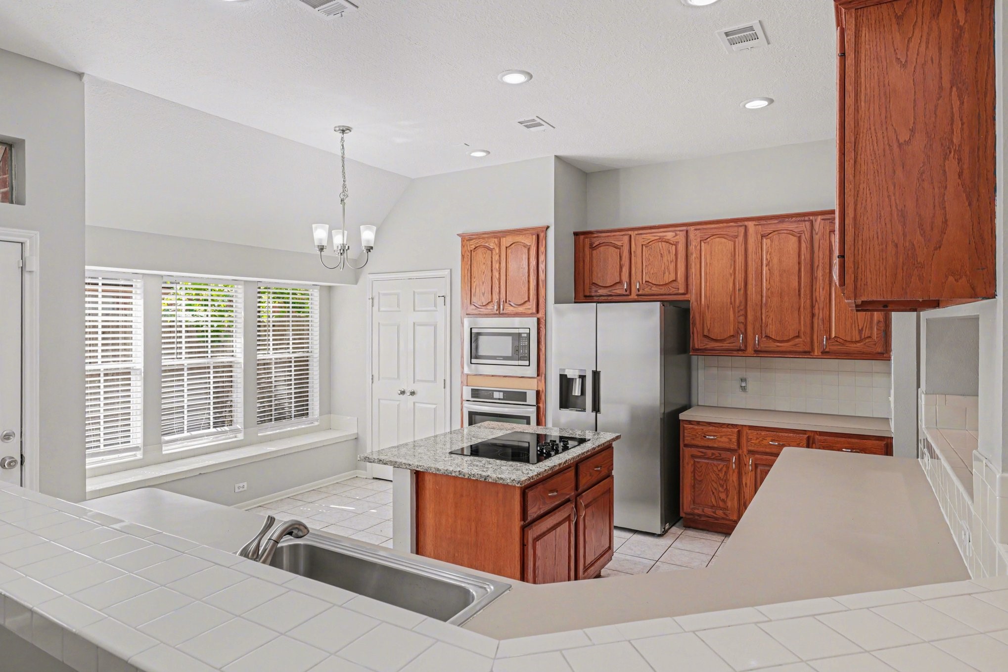 215 Bristol Bend Circle Spring, TX 77382 - Photo 9 of 25 a kitchen with stainless steel appliances granite countertop a refrigerator and a sink