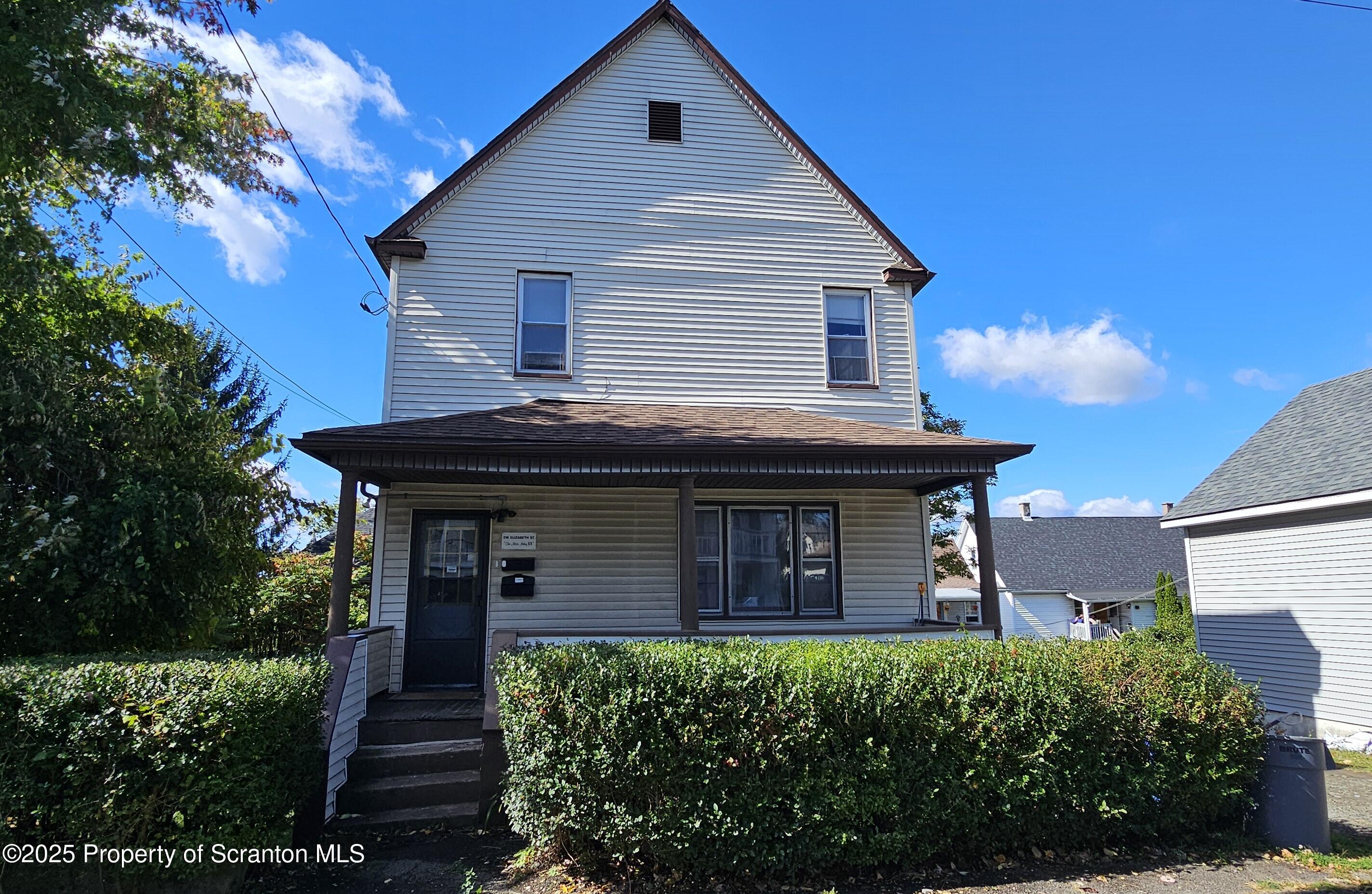 216 Elizabeth Street, Unit 2 Dunmore, PA 18512 - Photo 1 of 6 a front view of a house with a garden