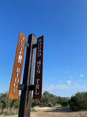 a view of a yard with trees in the background