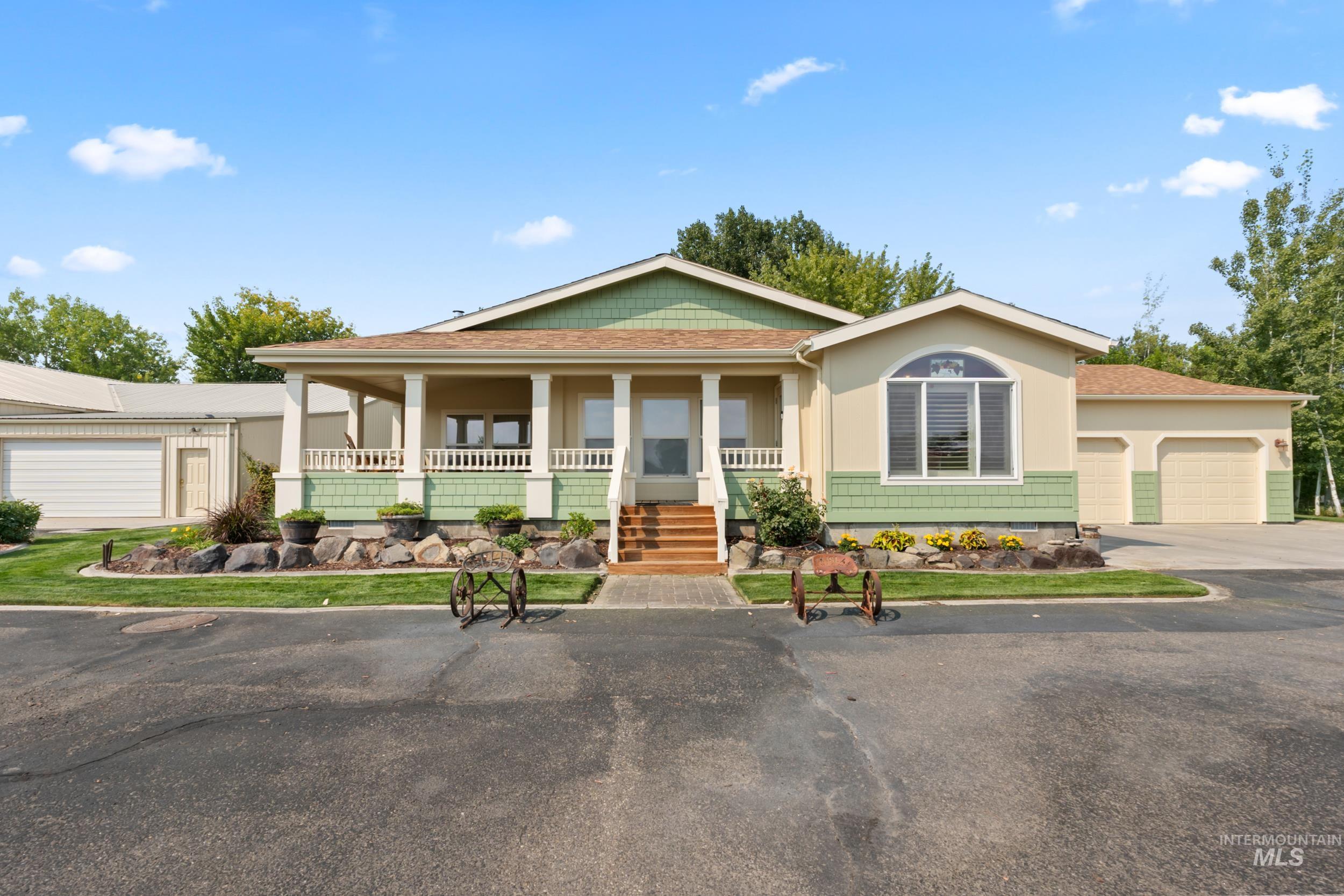 28283 Pearl Road Parma, ID 83660 - Photo 1 of 1 View of front of home with covered porch, driveway, an attached garage, and roof with shingles