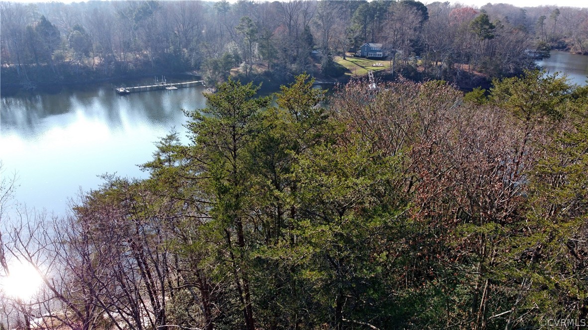 A Level Green Road Lancaster, VA 22503 - Photo 3 of 10 a backyard of a house with lots of green space and a lake view