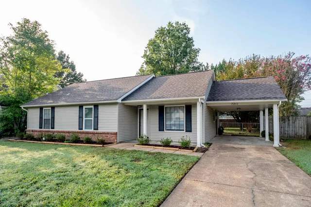 a front view of a house with a garden and plants