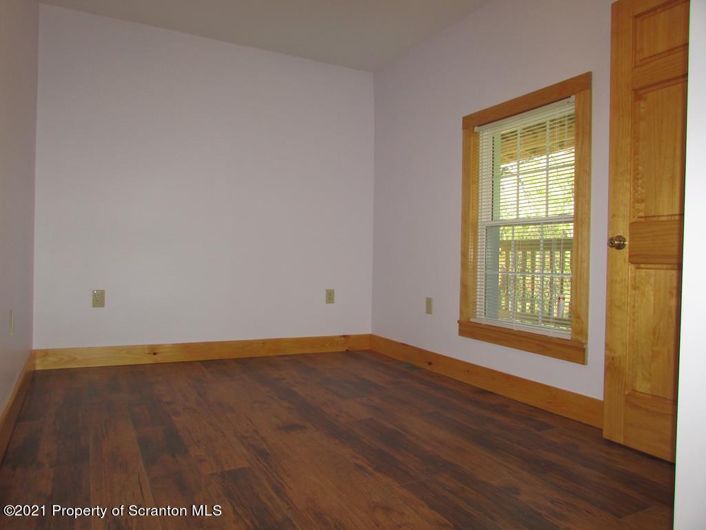 3328 Homets Ferry Road Wyalusing, PA 18853 - Photo 13 of 26 a view of an empty room with wooden floor and a window