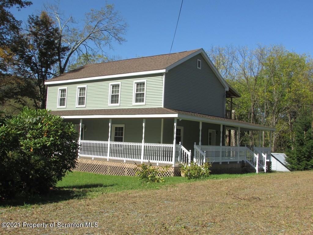 3328 Homets Ferry Road Wyalusing, PA 18853 - Photo 25 of 26 a front view of a house with a garden and plants