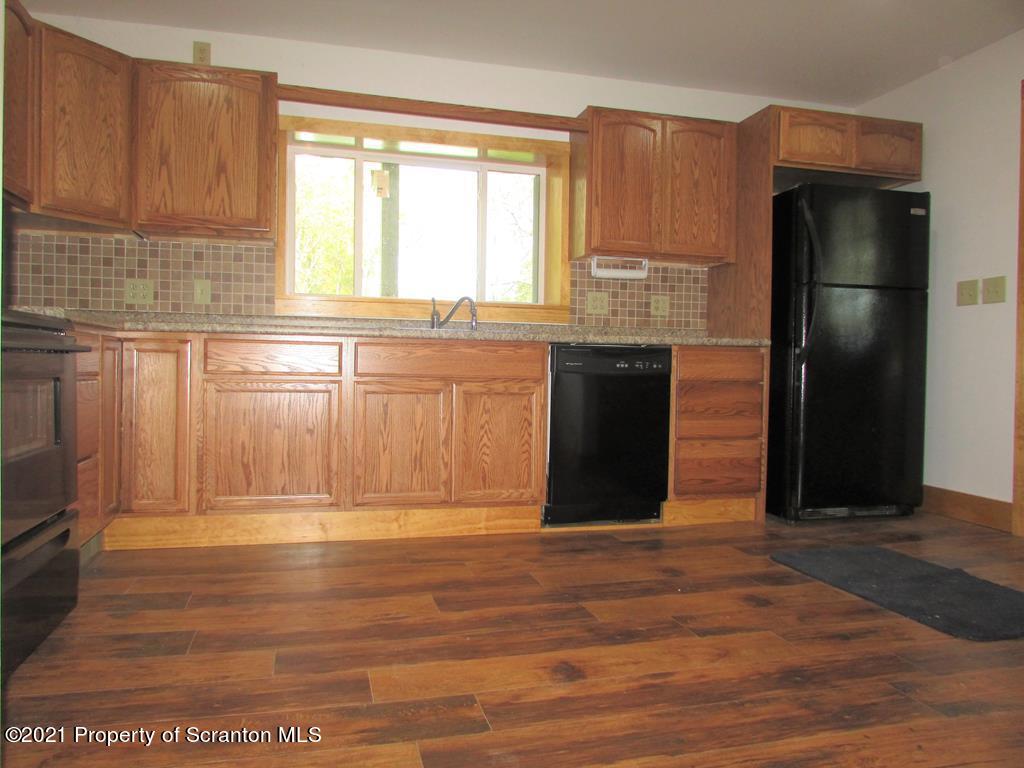 3328 Homets Ferry Road Wyalusing, PA 18853 - Photo 3 of 26 a kitchen with granite countertop a refrigerator and a sink