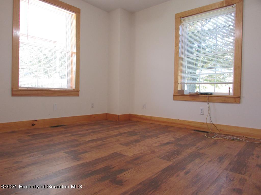 3328 Homets Ferry Road Wyalusing, PA 18853 - Photo 7 of 26 a view of an empty room with wooden floor and a window