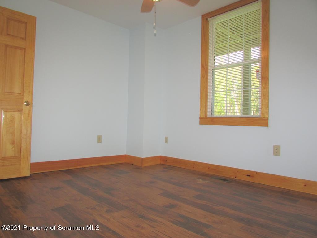 3328 Homets Ferry Road Wyalusing, PA 18853 - Photo 8 of 26 an empty room with wooden floor and windows