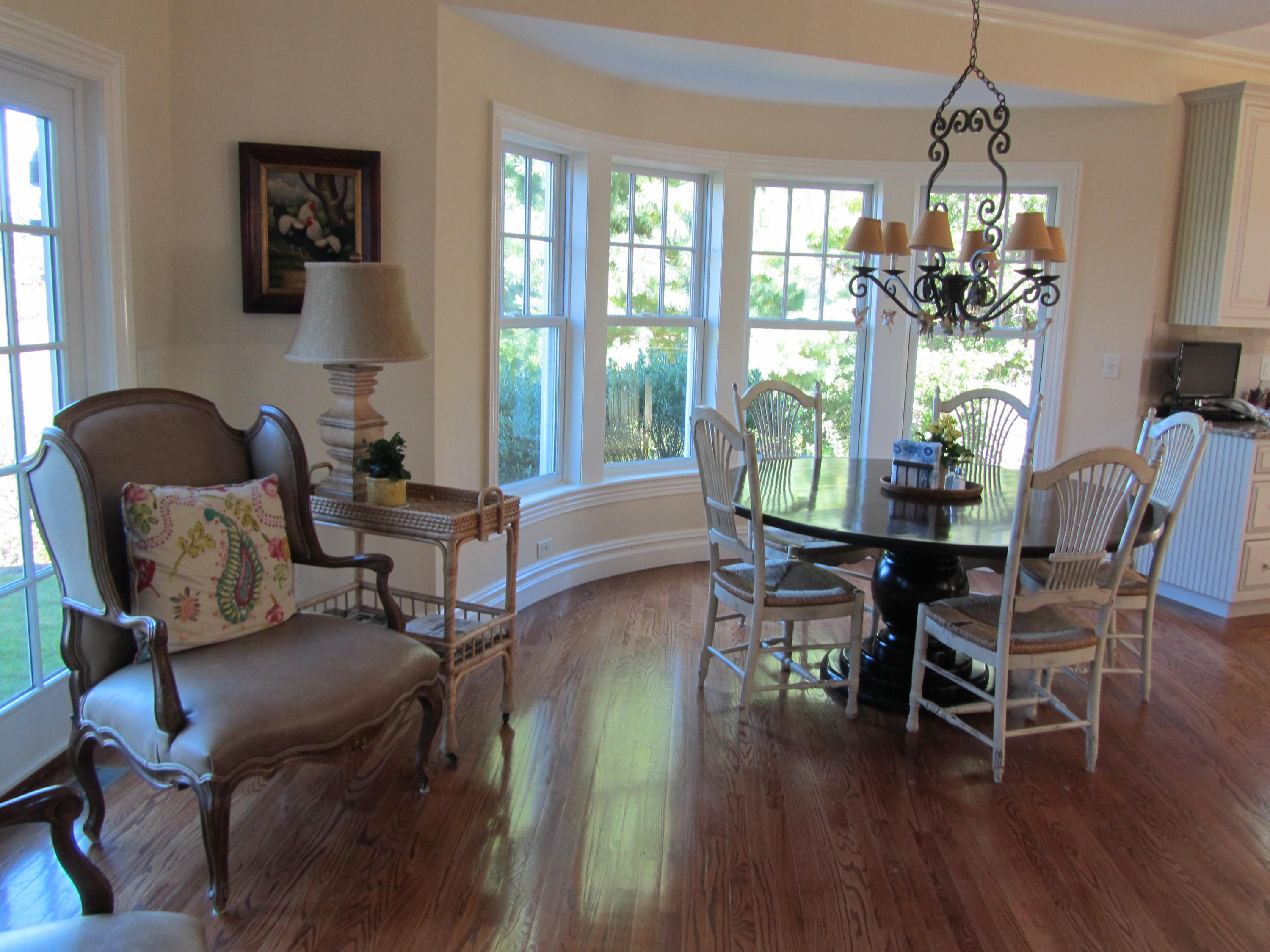 130 Main Street Osterville, MA 02655 - Photo 22 of 34 a dining room with wooden floor a chandelier a glass table and chairs