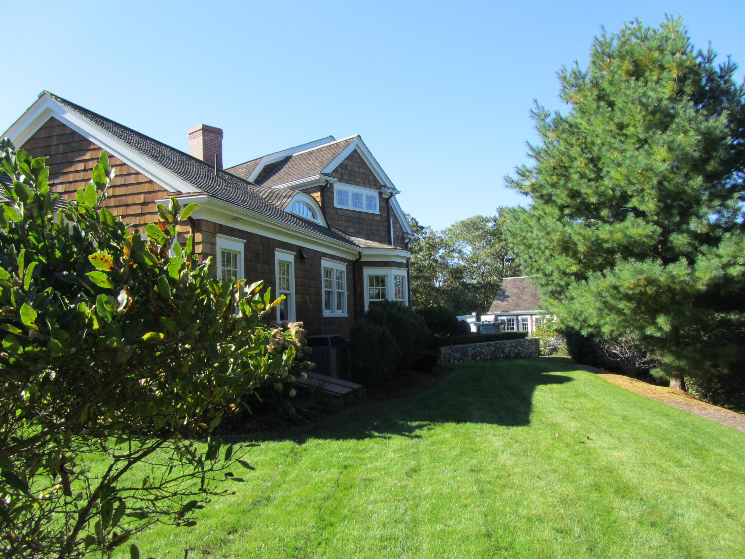 130 Main Street Osterville, MA 02655 - Photo 7 of 34 a front view of a house with a yard