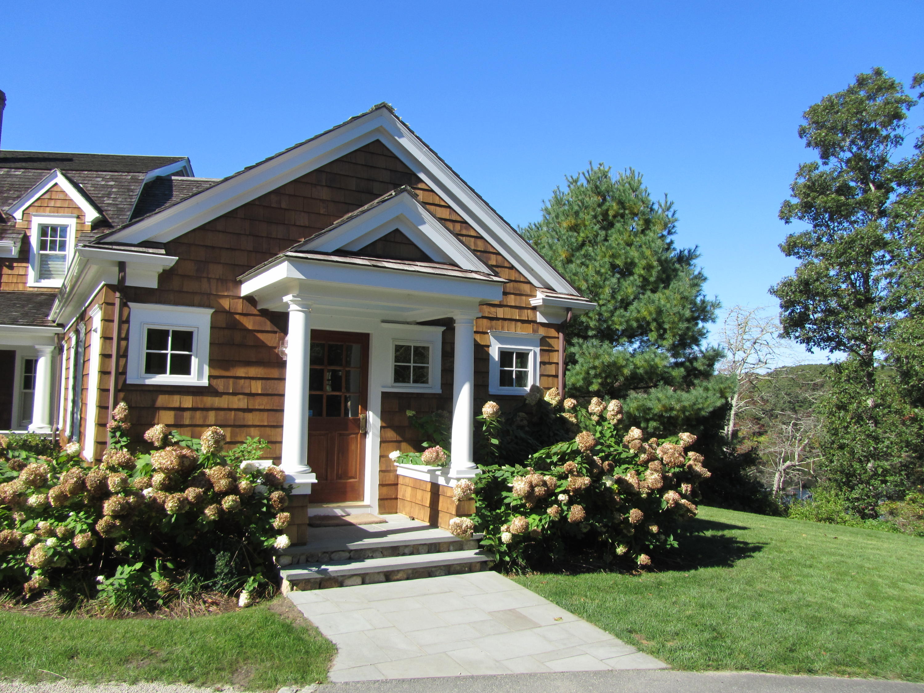 130 Main Street Osterville, MA 02655 - Photo 9 of 34 a front view of a house with a garden