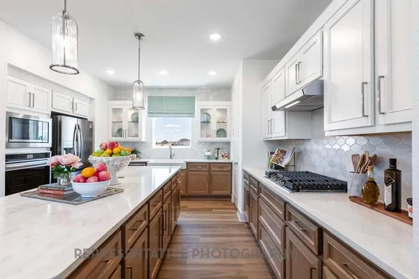 a kitchen with stainless steel appliances granite countertop a sink stove and cabinets